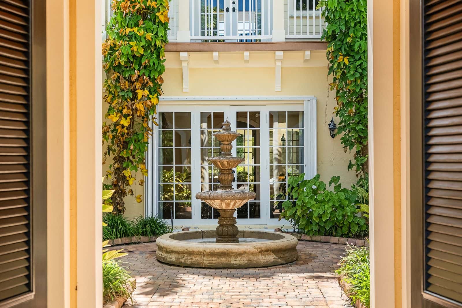 Beautiful entry way looking into a courtyard with water fountain.